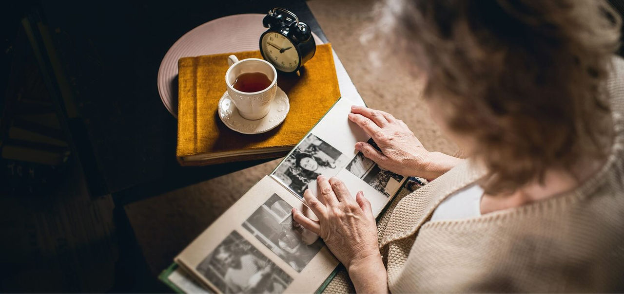 a woman looking at a photo album